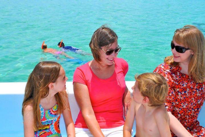 a group of people standing next to a body of water