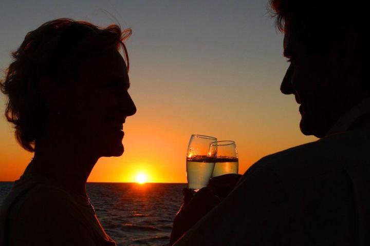 a man standing in front of a sunset