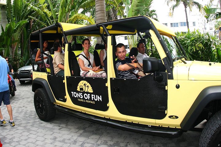 a group of people riding on the back of a truck