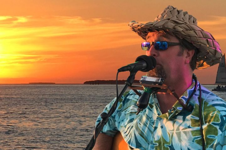 a man standing next to a body of water