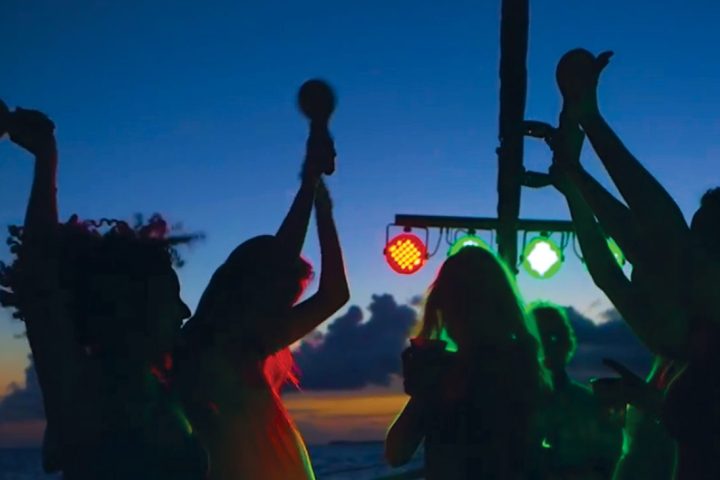 a group of people in front of a sunset