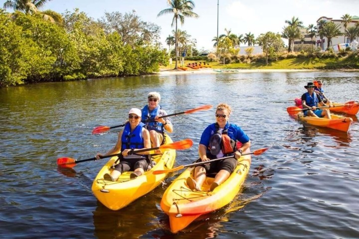 a group of people in a small boat in a body of water